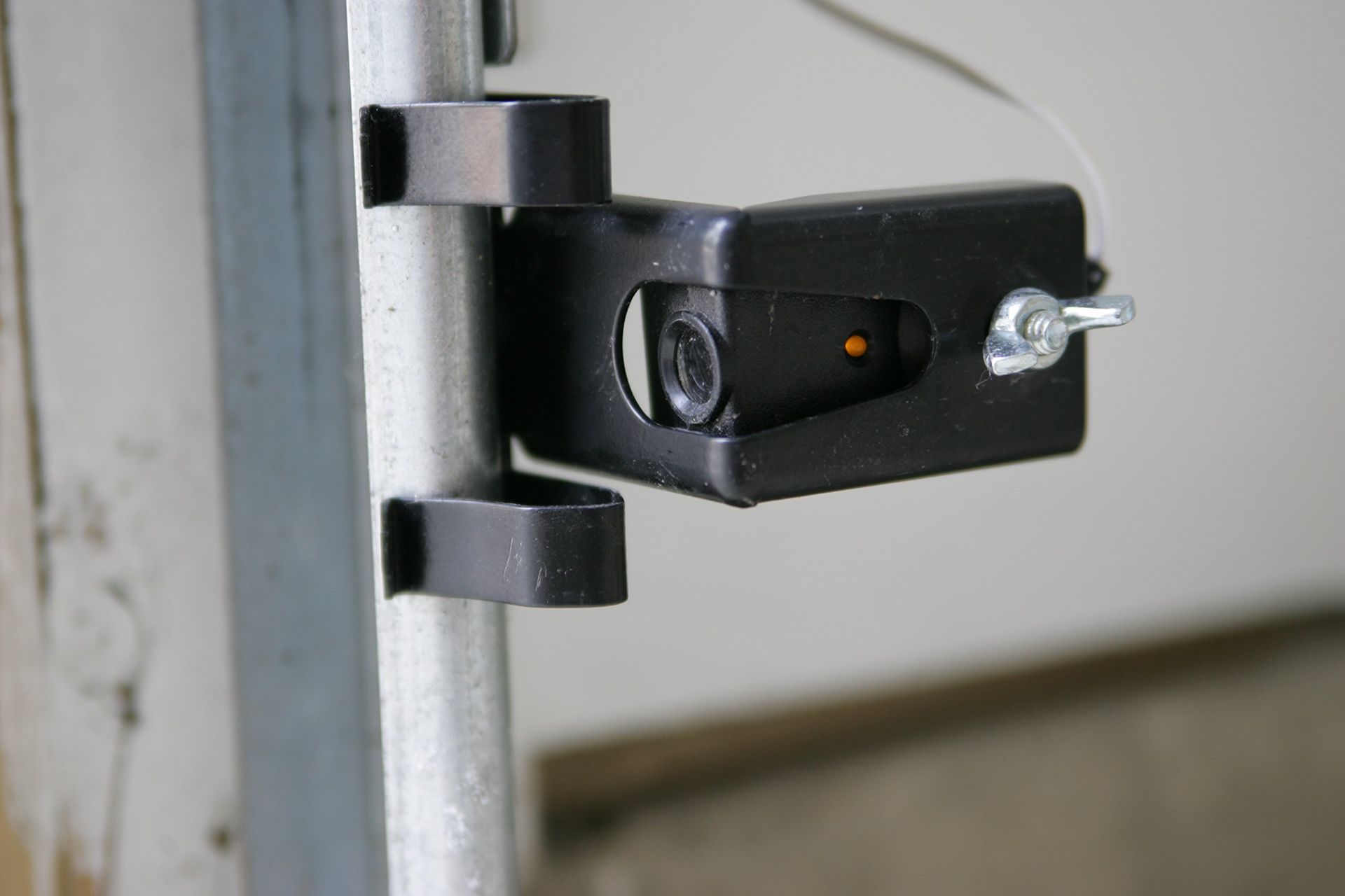 A close up of a black object attached to a metal pole.