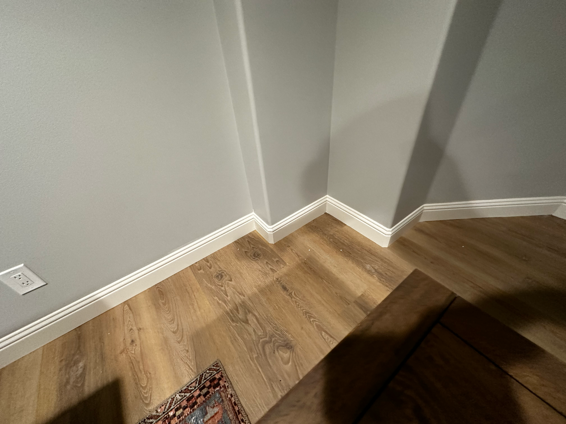 A living room with hardwood floors and white trim.