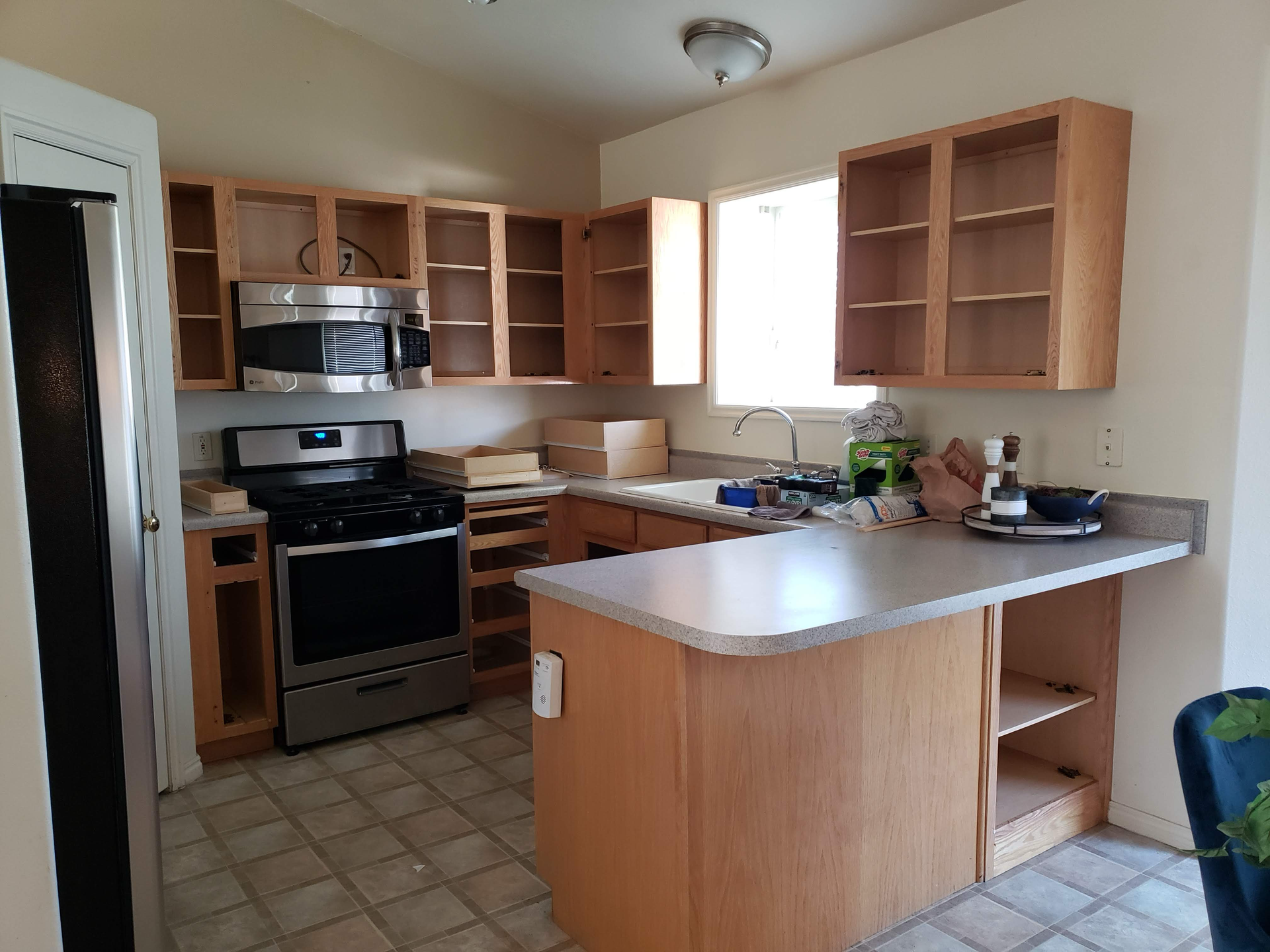 A kitchen with stainless steel appliances and wooden cabinets