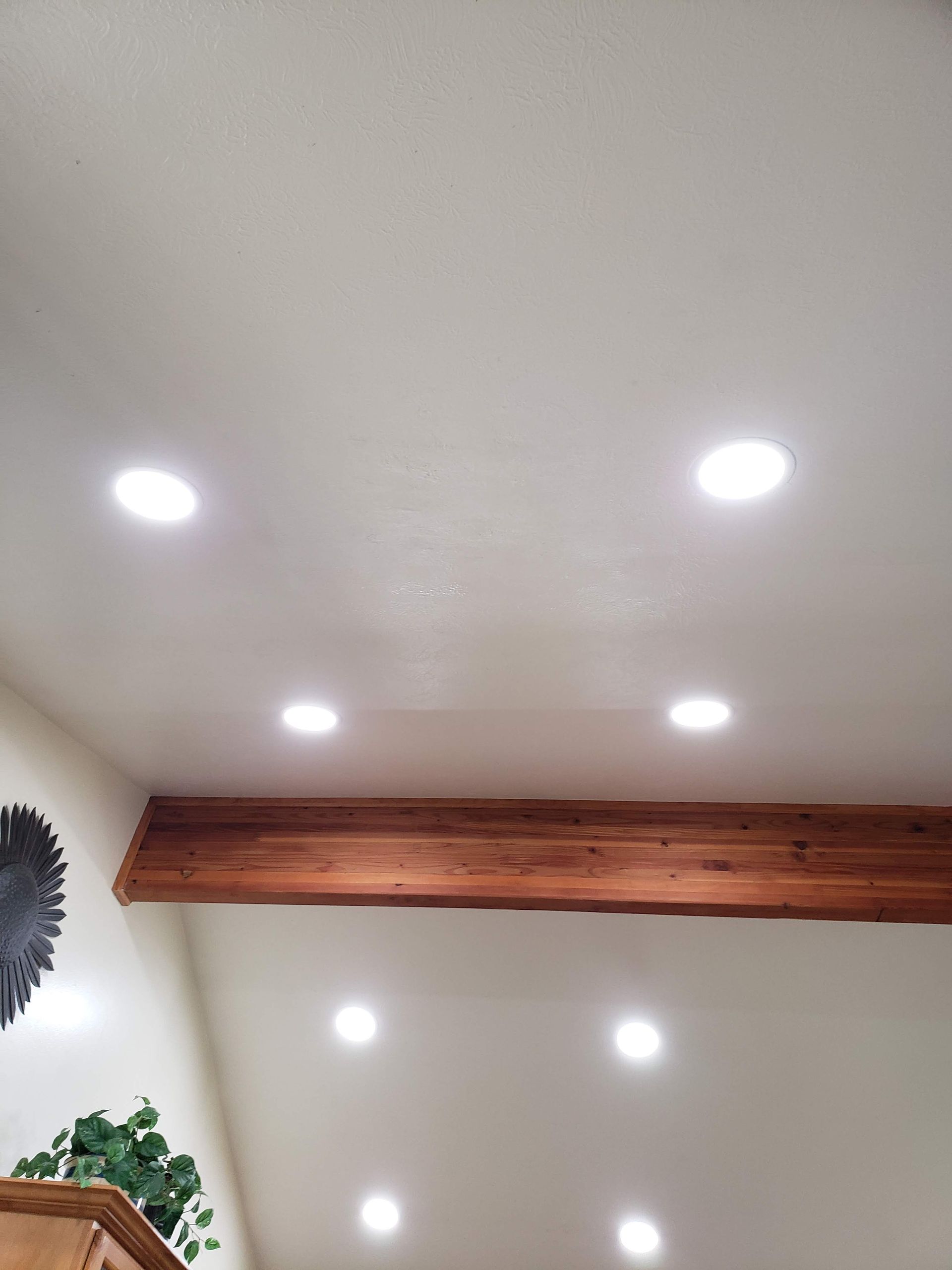 A room with a white ceiling and wooden beams.