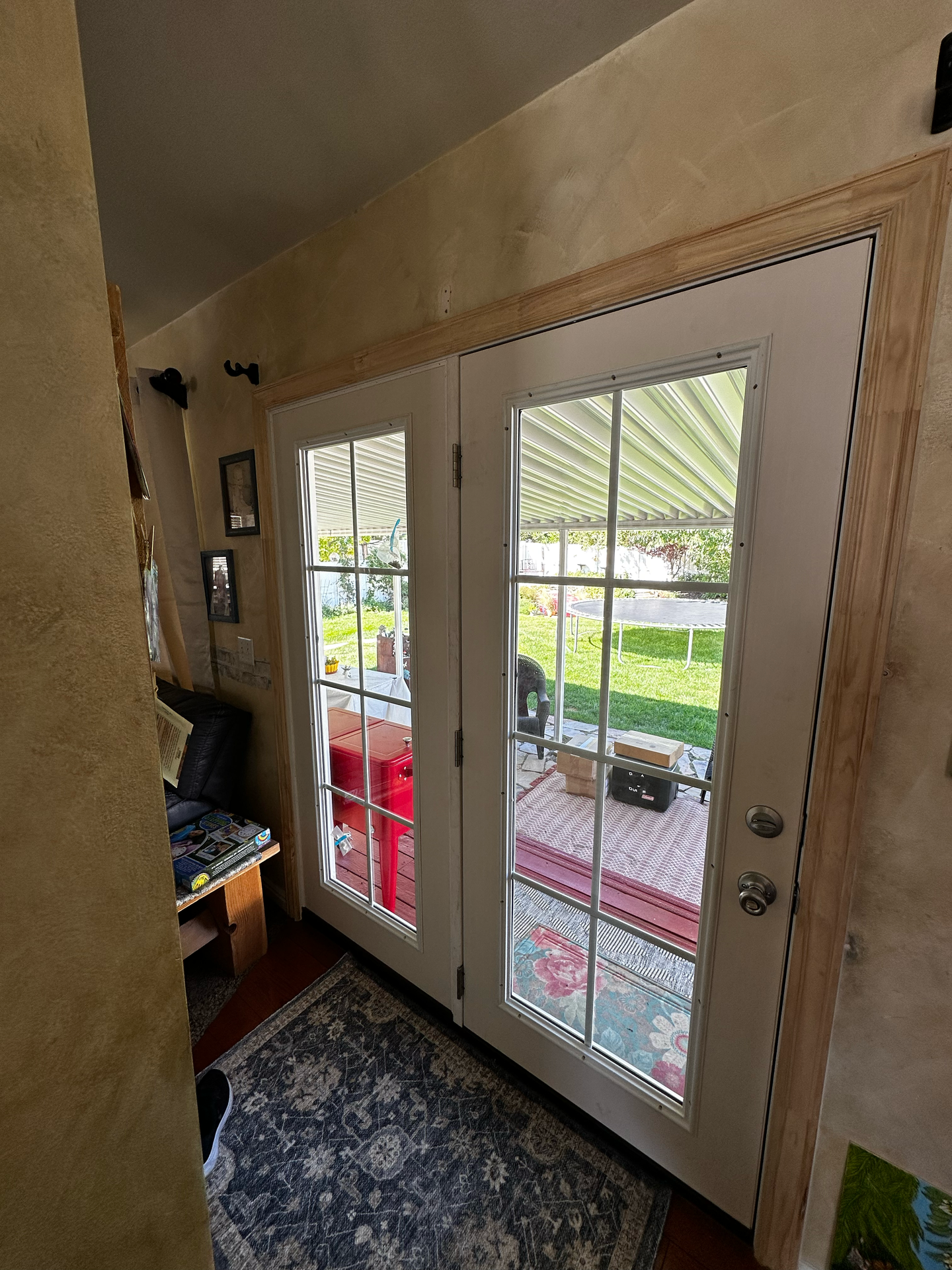 A room with a rug and sliding glass doors leading to a patio.