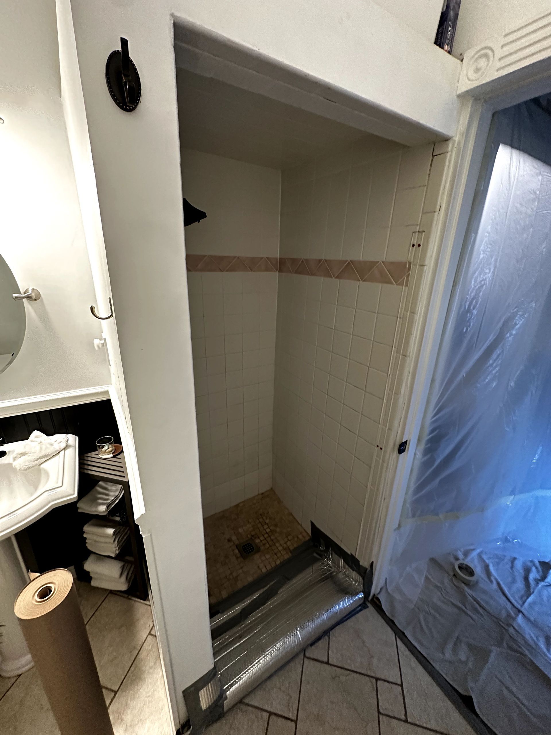 A bathroom with a shower stall and a toilet.