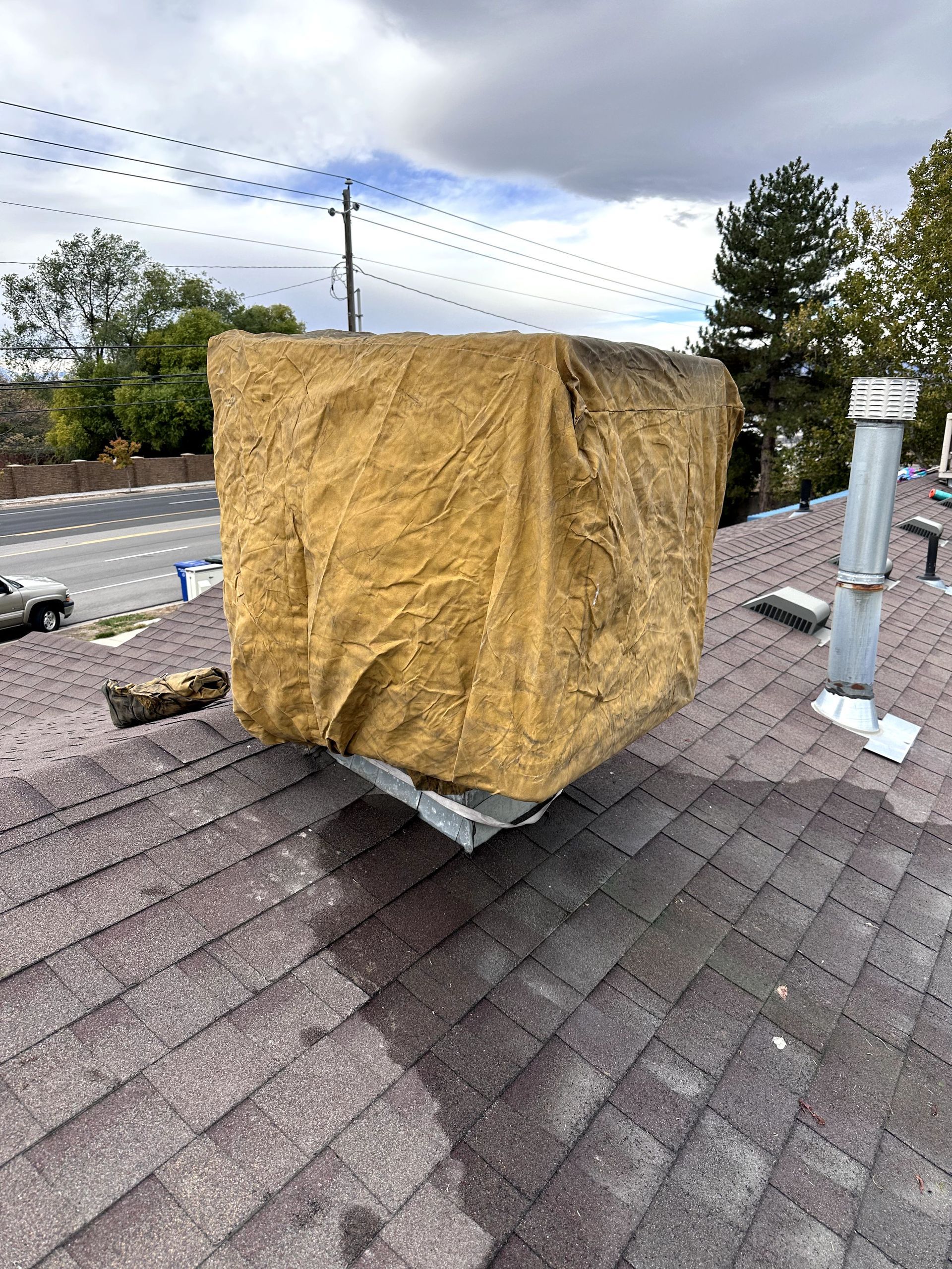 A large piece of fabric is sitting on top of a roof.