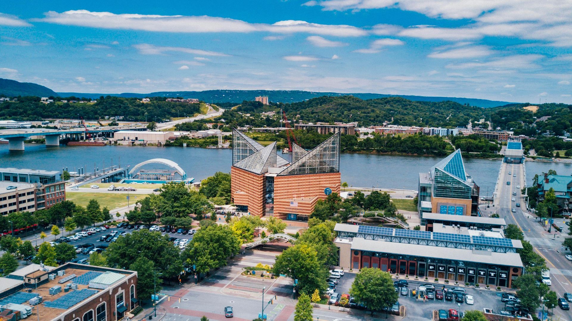 An aerial view of a city with a river in the background.