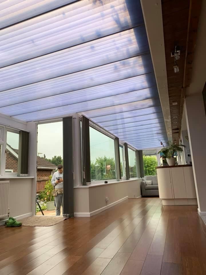 a large room with hardwood floors and a clear ceiling .
