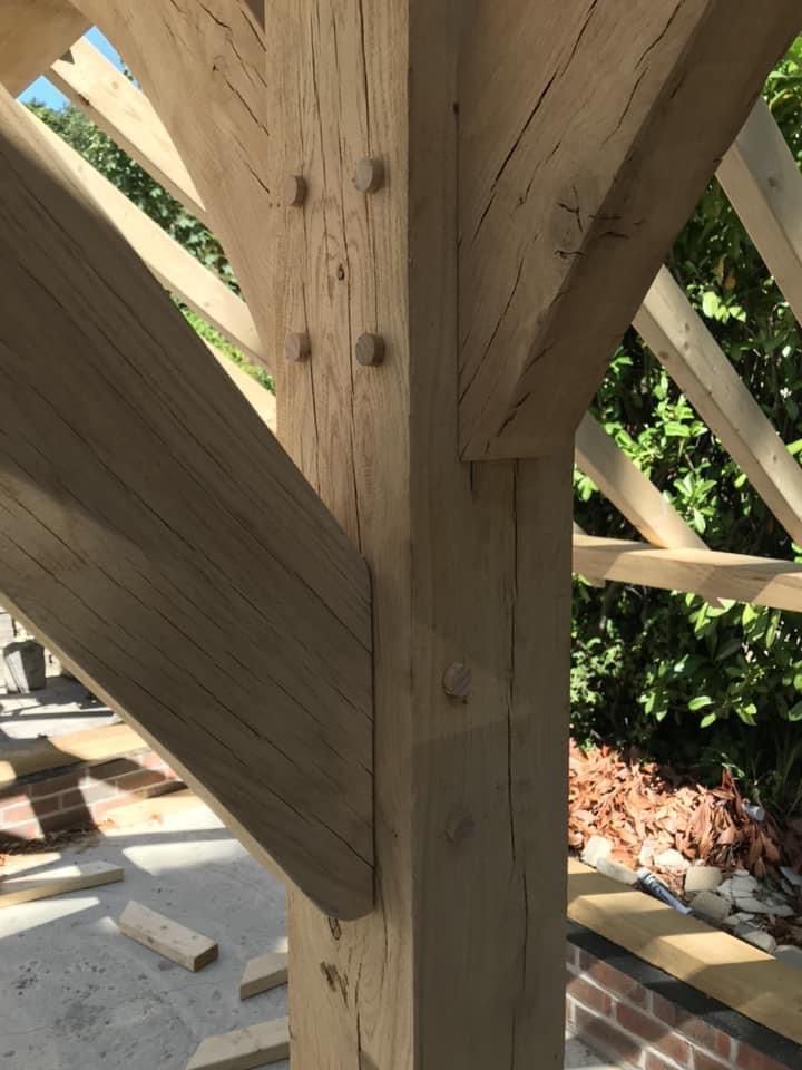 a close up of a wooden structure with a brick wall in the background