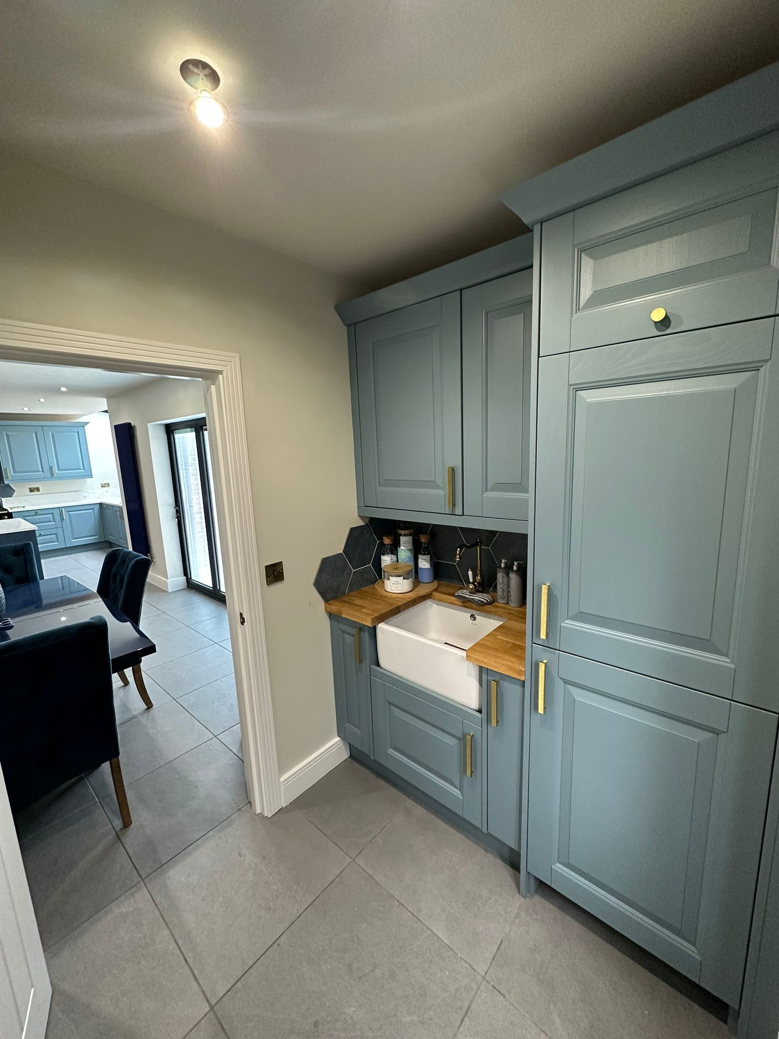 a kitchen with blue cabinets and a white sink .