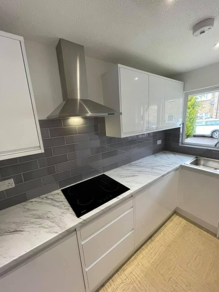 a kitchen with white cabinets and a stove top oven .