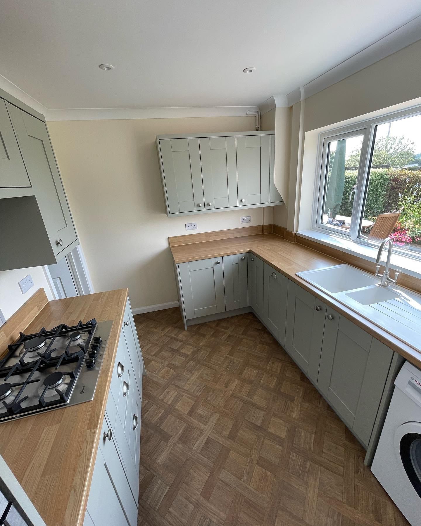 a kitchen with a stove top oven , sink , and washing machine .