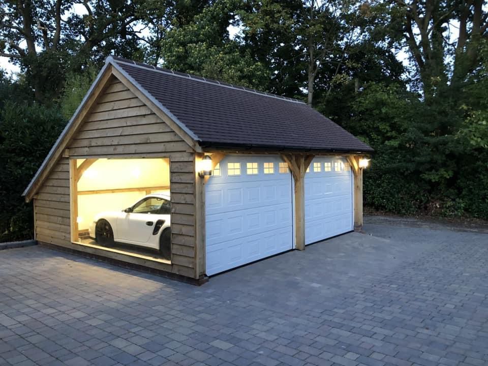 a car is parked in a garage with the doors open .