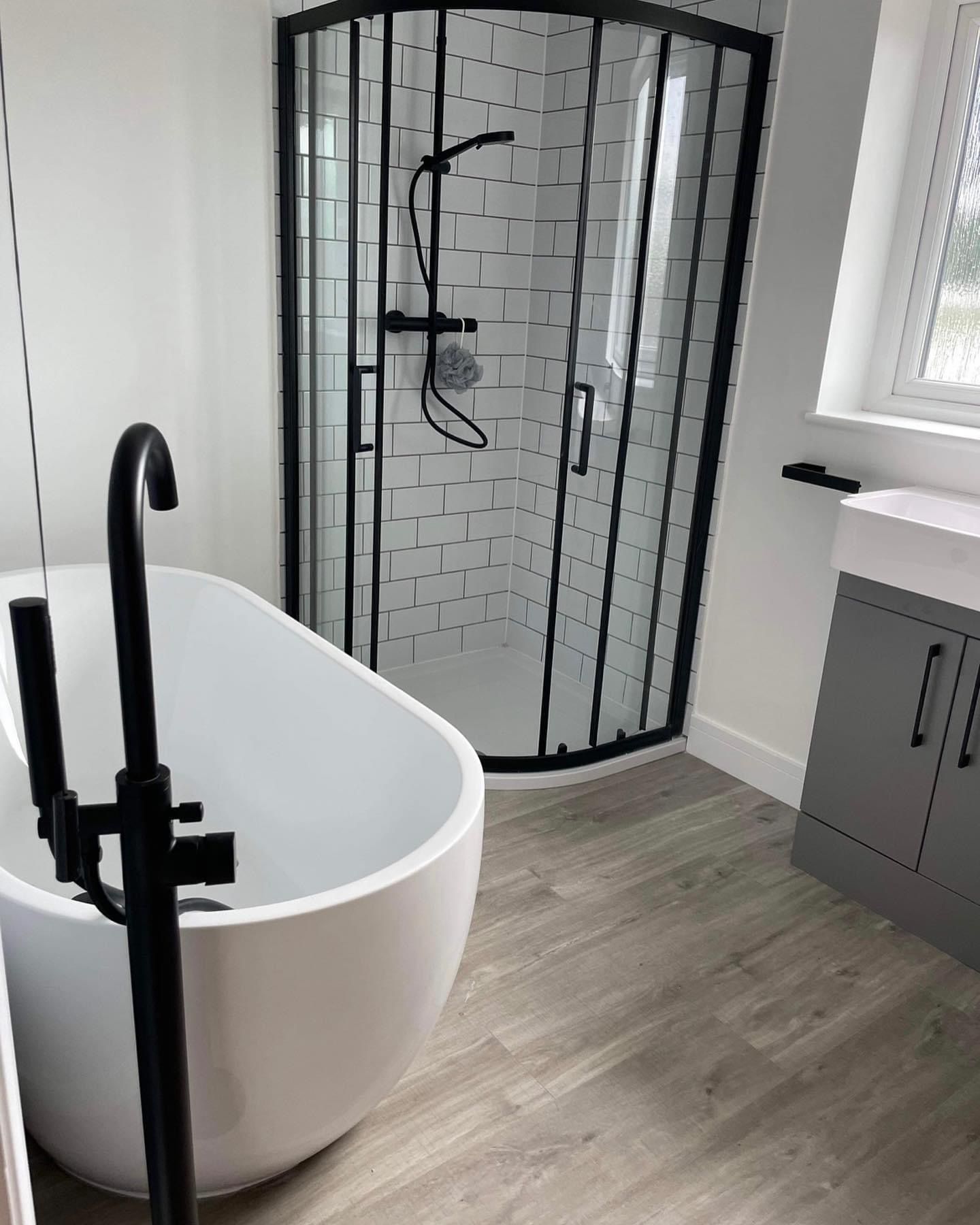 a bathroom with a bathtub and a shower stall .