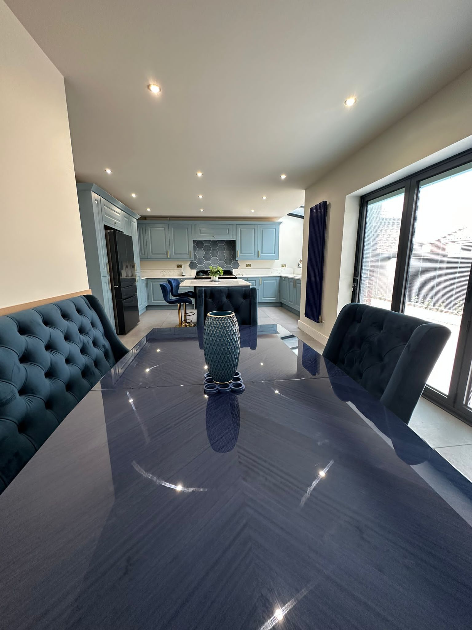 a dining room table with a vase on top of it in a kitchen .