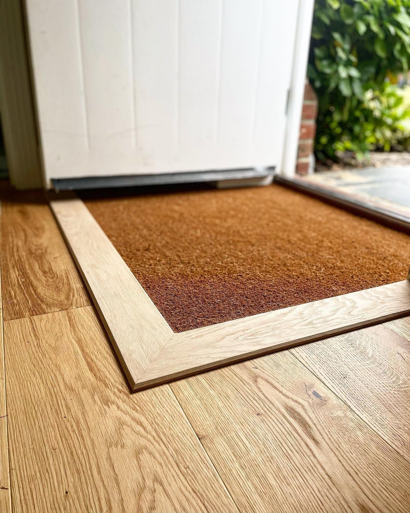 a door mat is sitting on a wooden floor next to a door .