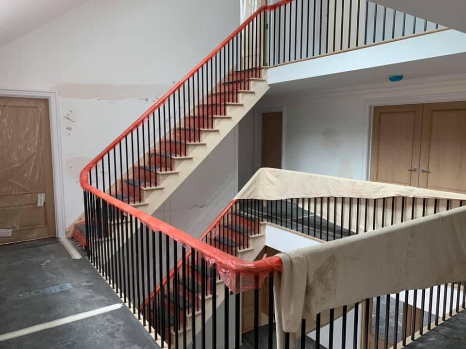 a staircase with a red railing in a building