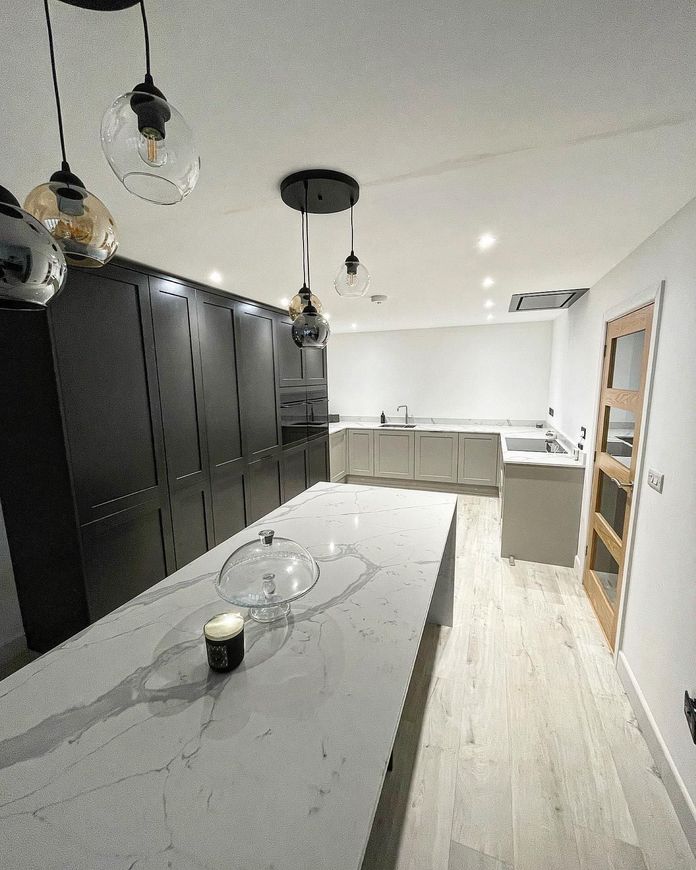 a kitchen with a large island and a candle on it .