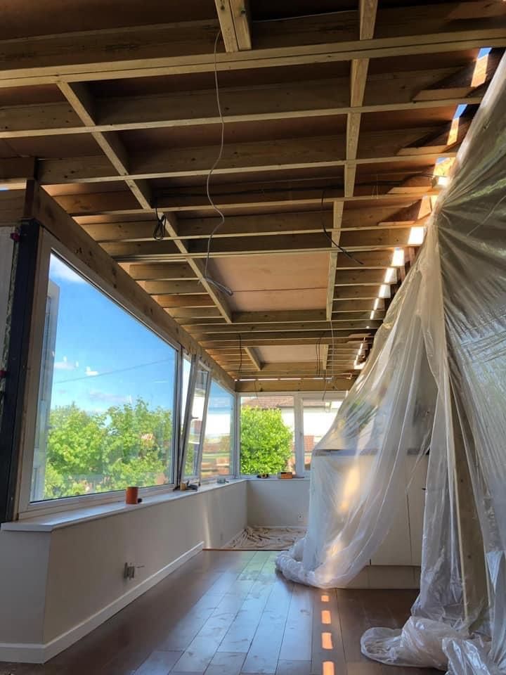 a large room with a lot of windows and a wooden ceiling .