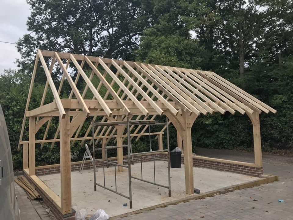 a wooden structure with a roof is being built by Harman Carpentry 