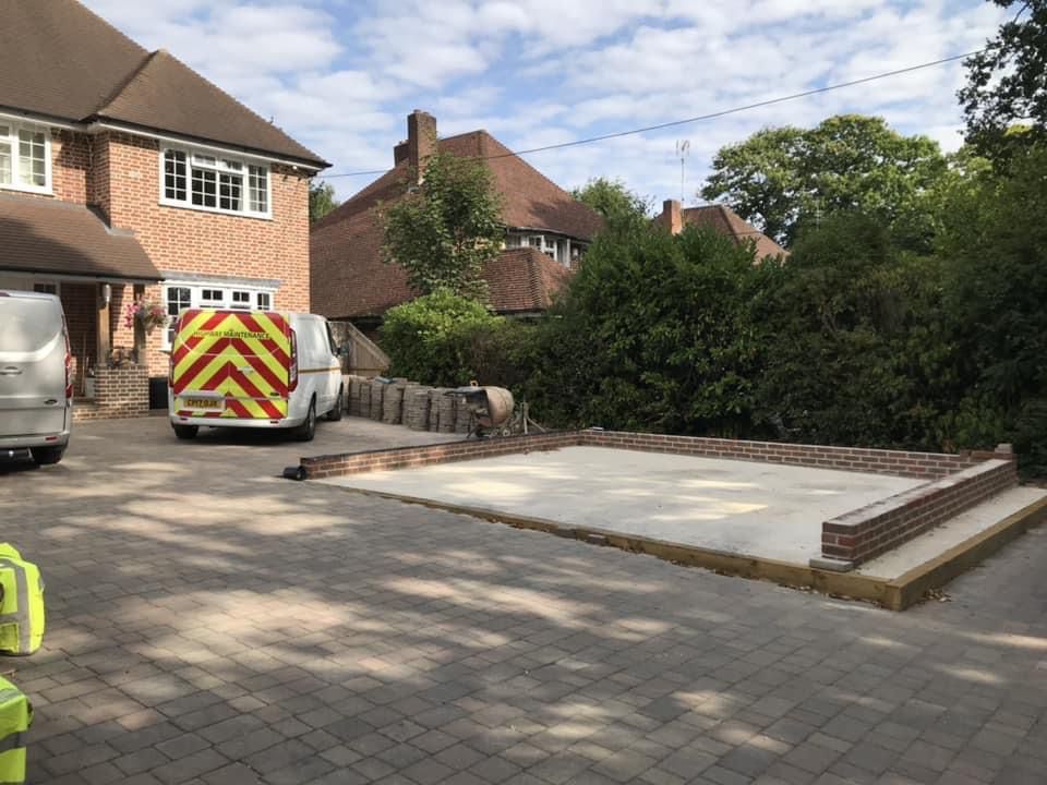 a van is parked in a driveway in front of a house .