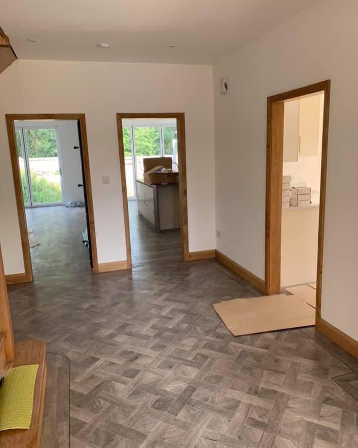 a living room with a wooden floor and white walls .