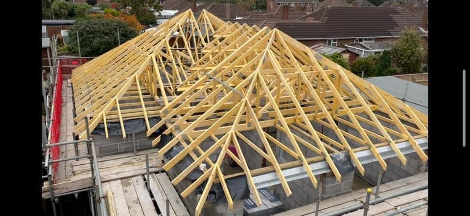 a large wooden roof is being built on top of a house .