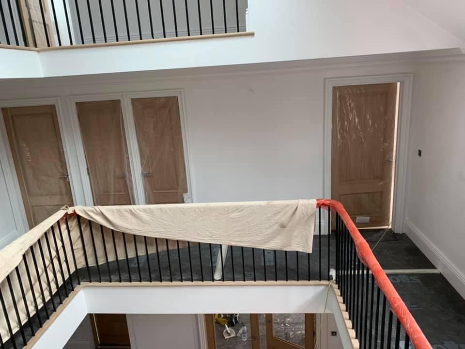 a view of a staircase from the second floor of a house under construction .