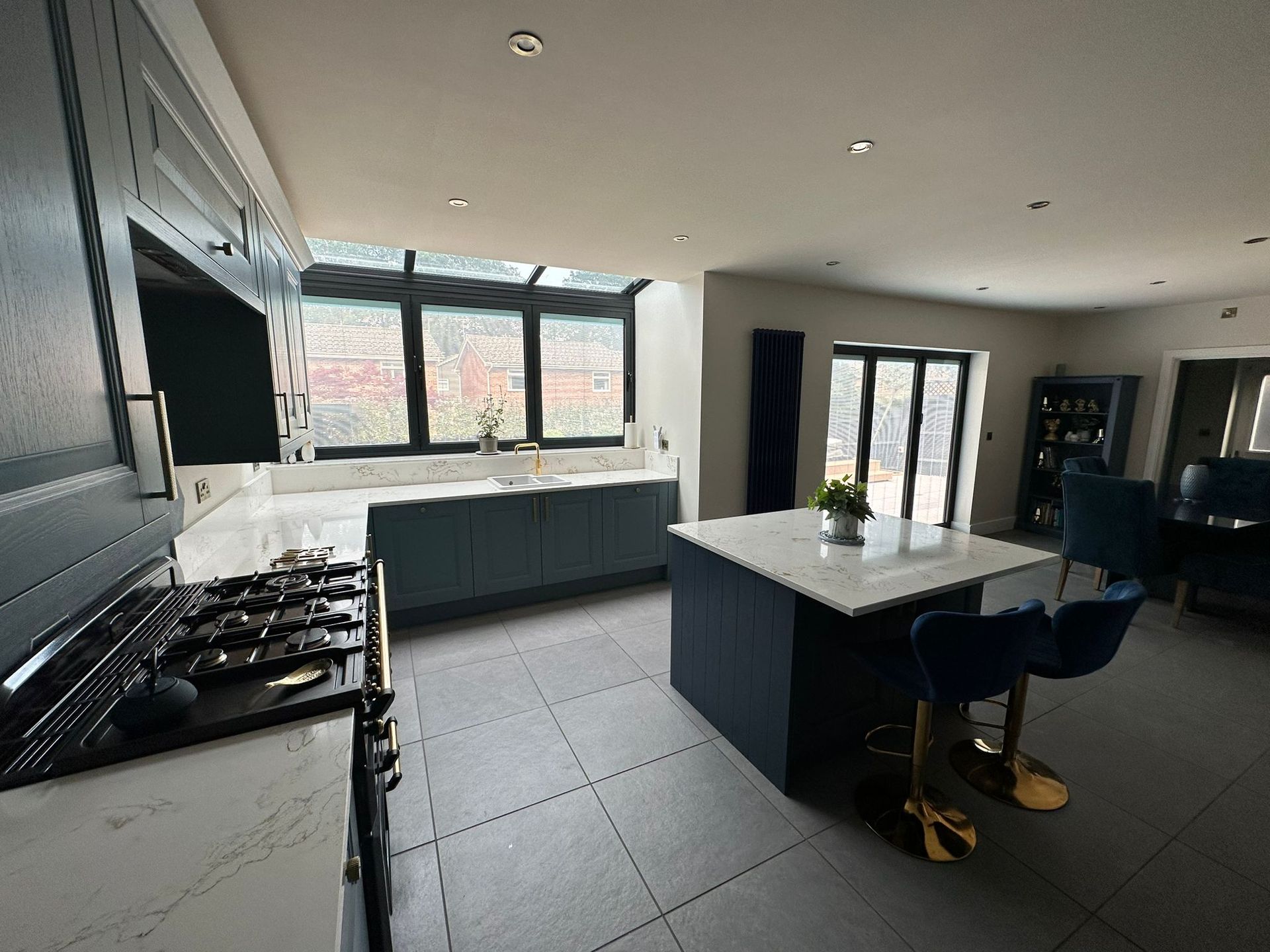 a kitchen with a large island in the middle and a stove top oven .