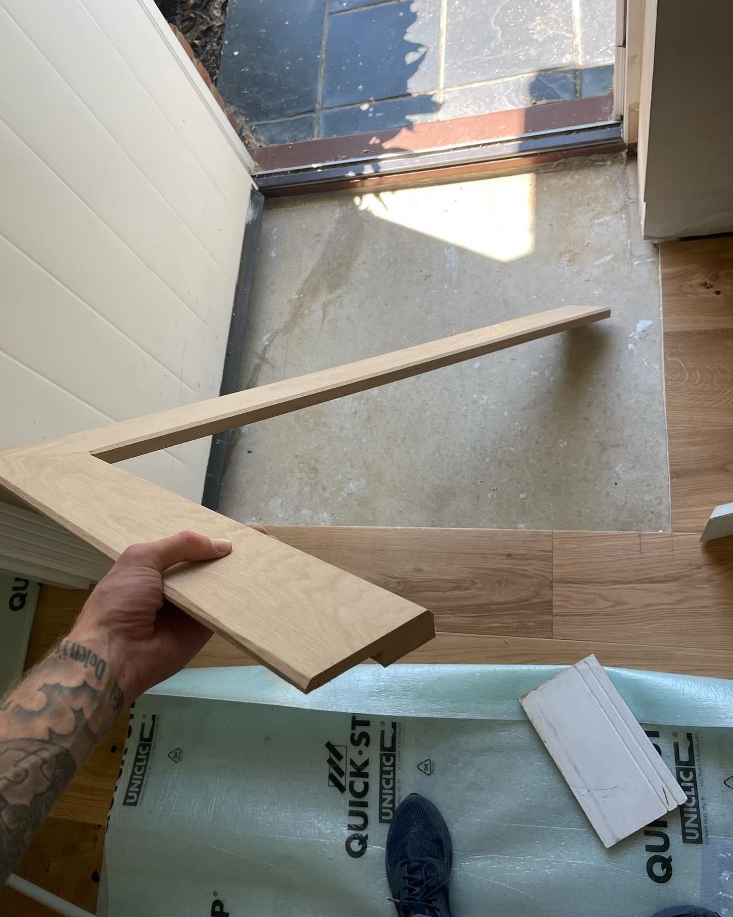 a person is holding a piece of wood in their hand .