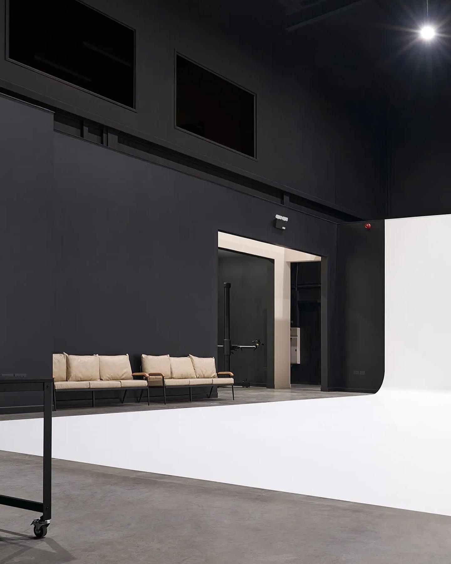 a room with black walls and a white floor