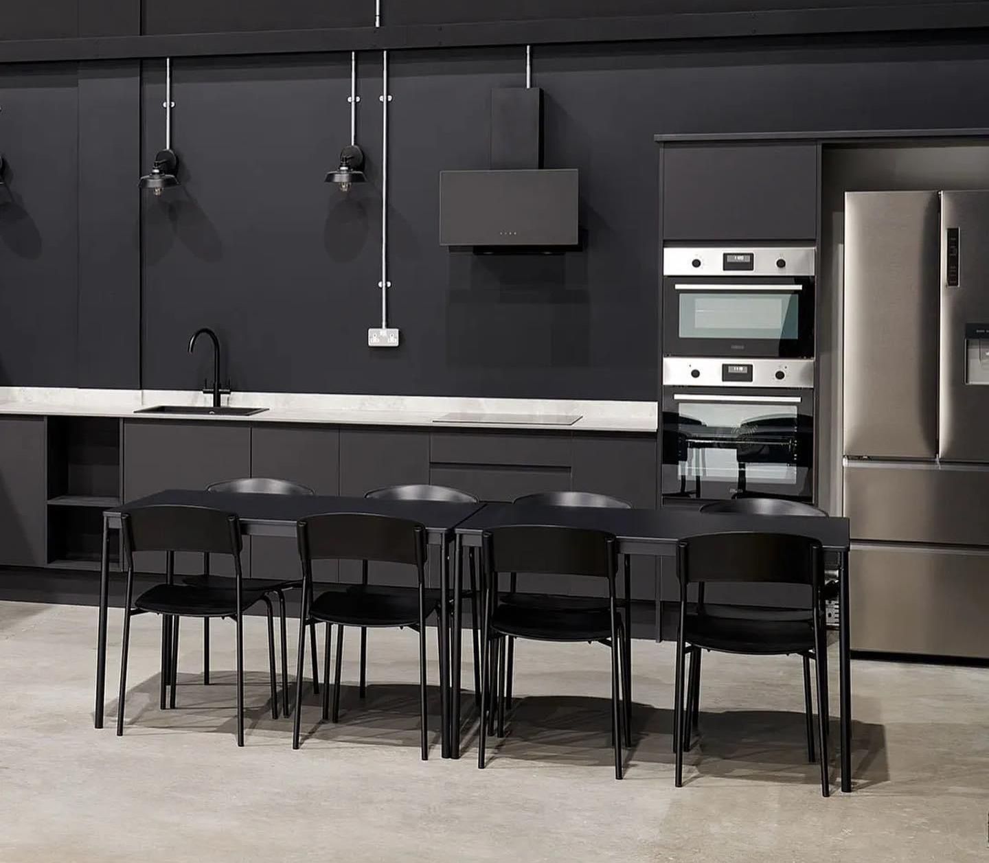 a kitchen with a table and chairs and a refrigerator