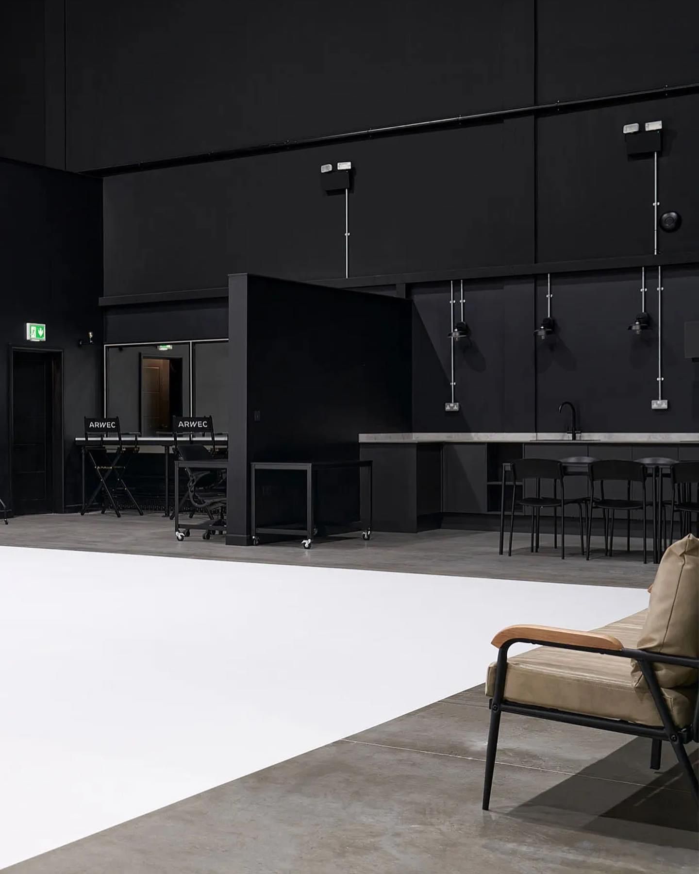 a chair is sitting in a room with black walls