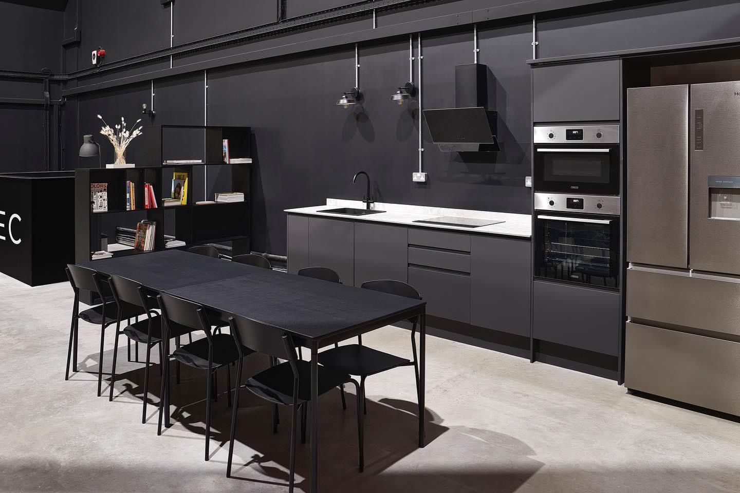 a kitchen with a table and chairs and a refrigerator