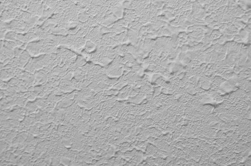 A close up of a white wall with a texture.