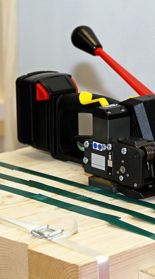 A machine is sitting on top of a wooden table.