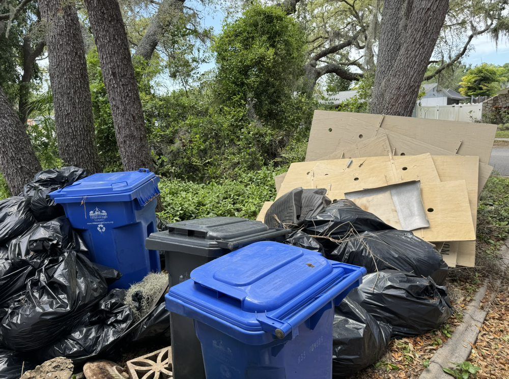 A pile of trash is sitting on the side of the road.
