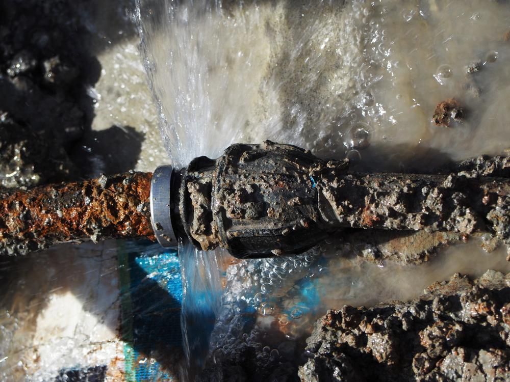 A Rusty Pipe With Water Coming Out of It — Wahoo Plumbing in Mountain Creek, QLD