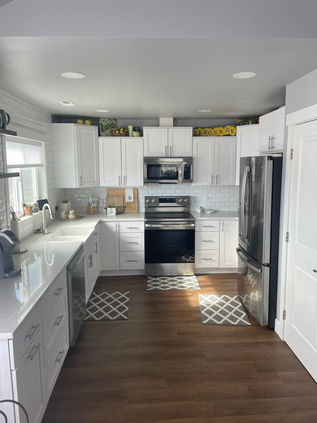 A kitchen with white cabinets and stainless steel appliances.