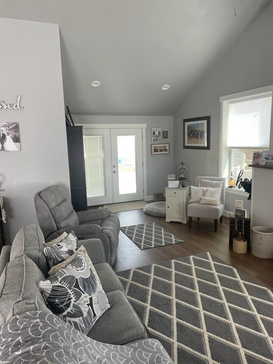 A living room with a couch , chairs , and a rug.