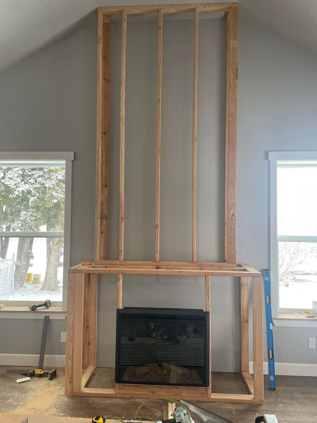 A fireplace is being built in a living room.
