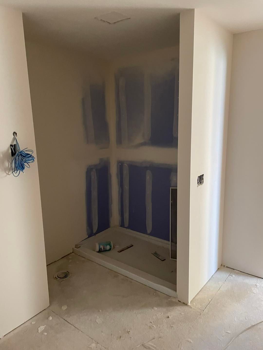 A room that is being remodeled with drywall on the walls.