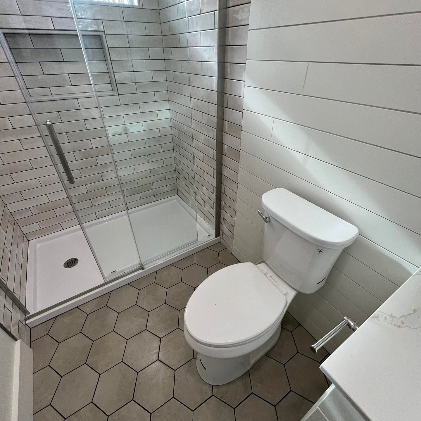 A bathroom with a toilet and a shower stall