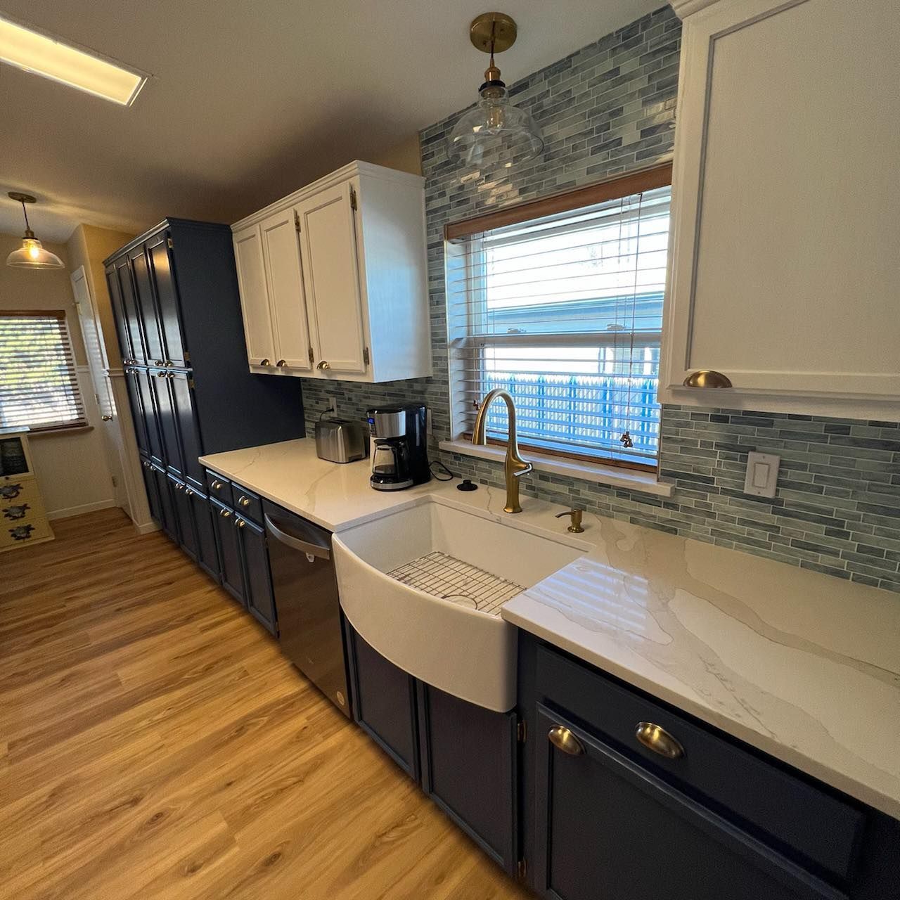 A kitchen with blue cabinets and a white sink.