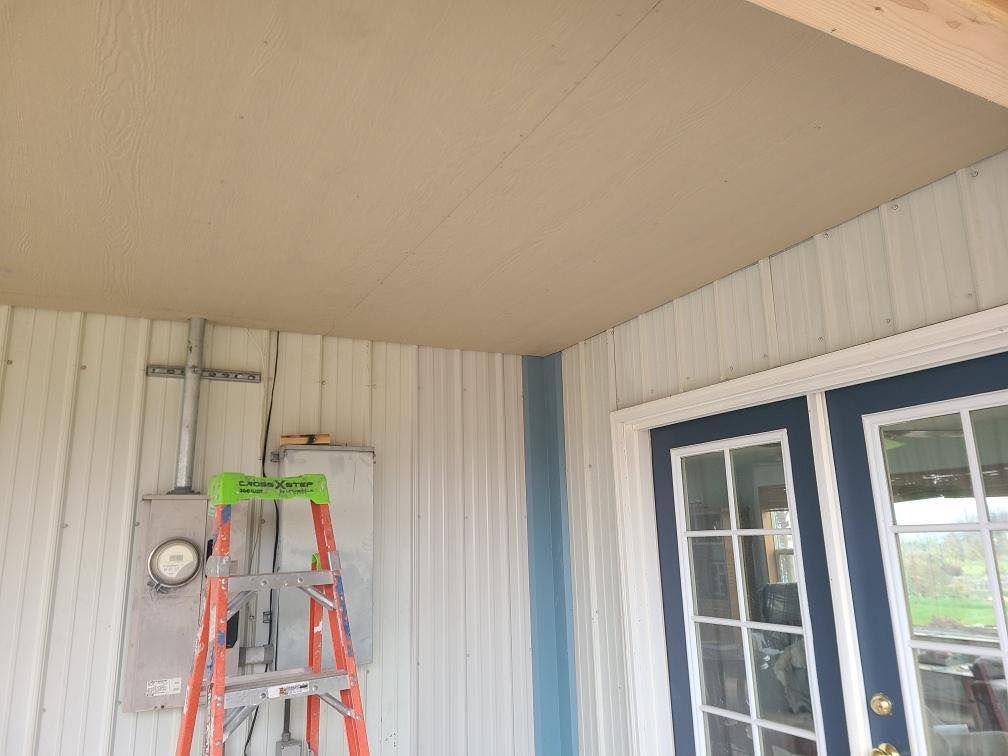 A ladder is hanging from the ceiling of a building next to a door.