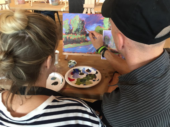 acrylic painter teaching a student how to paint
