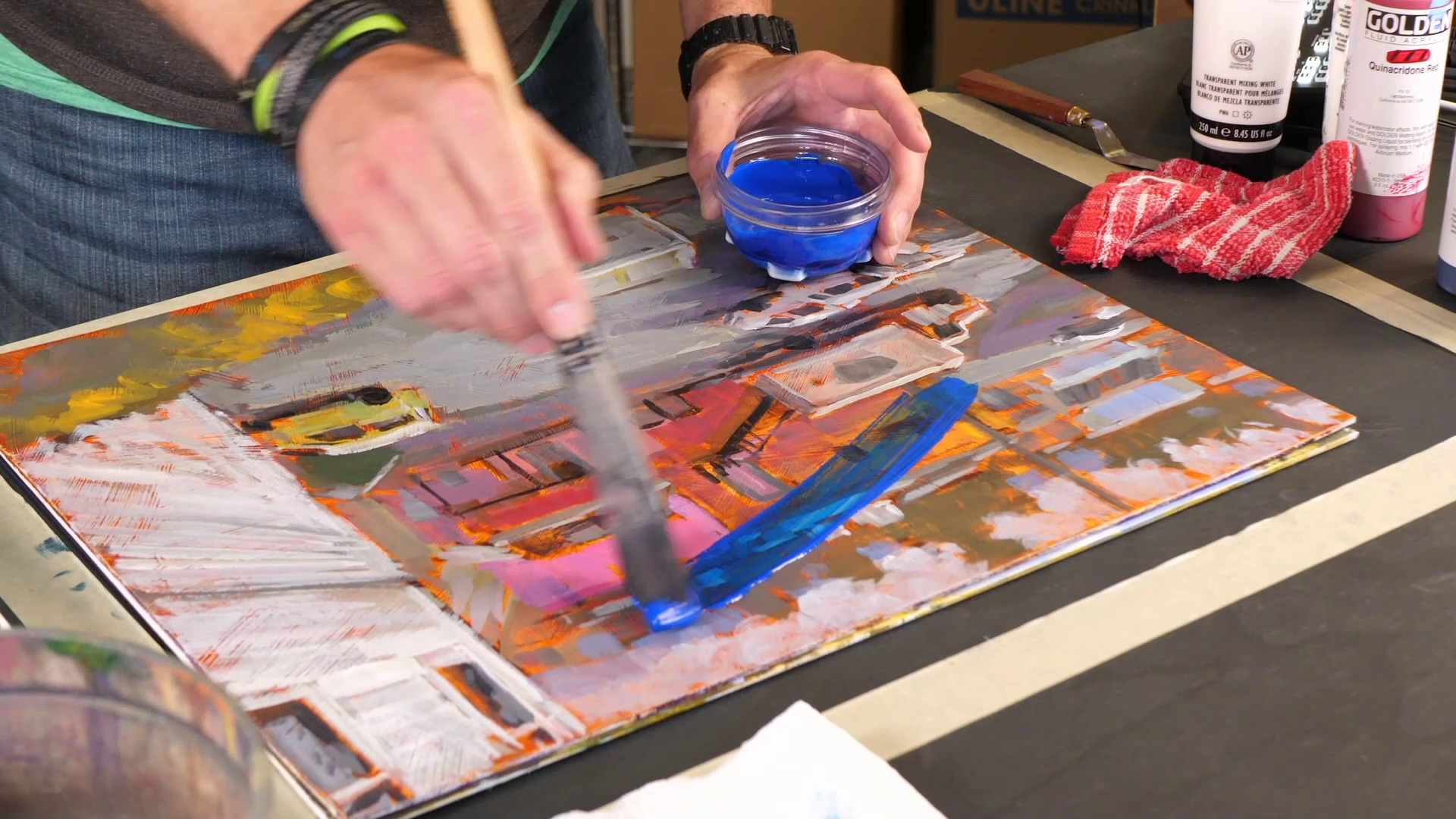 man mixing glazes in an acrylic painting