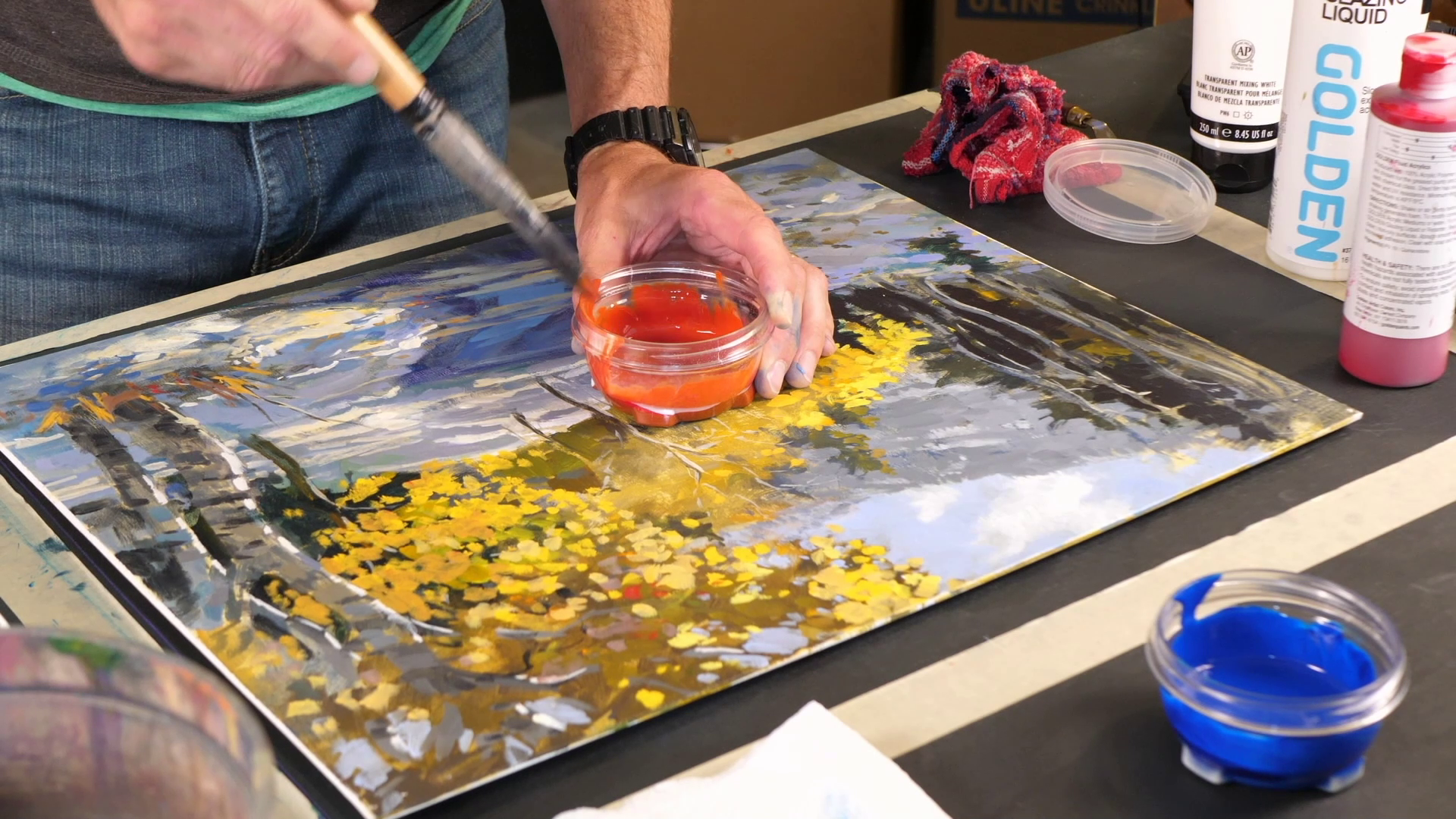 man mixing glazes in an acrylic painting