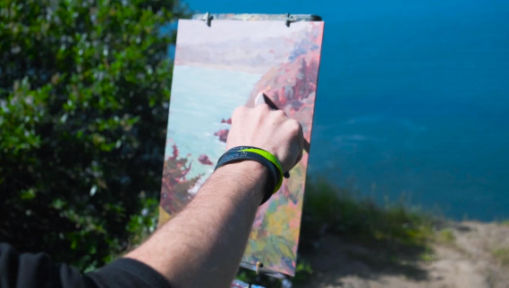 acrylic painter painting on a cliff outside