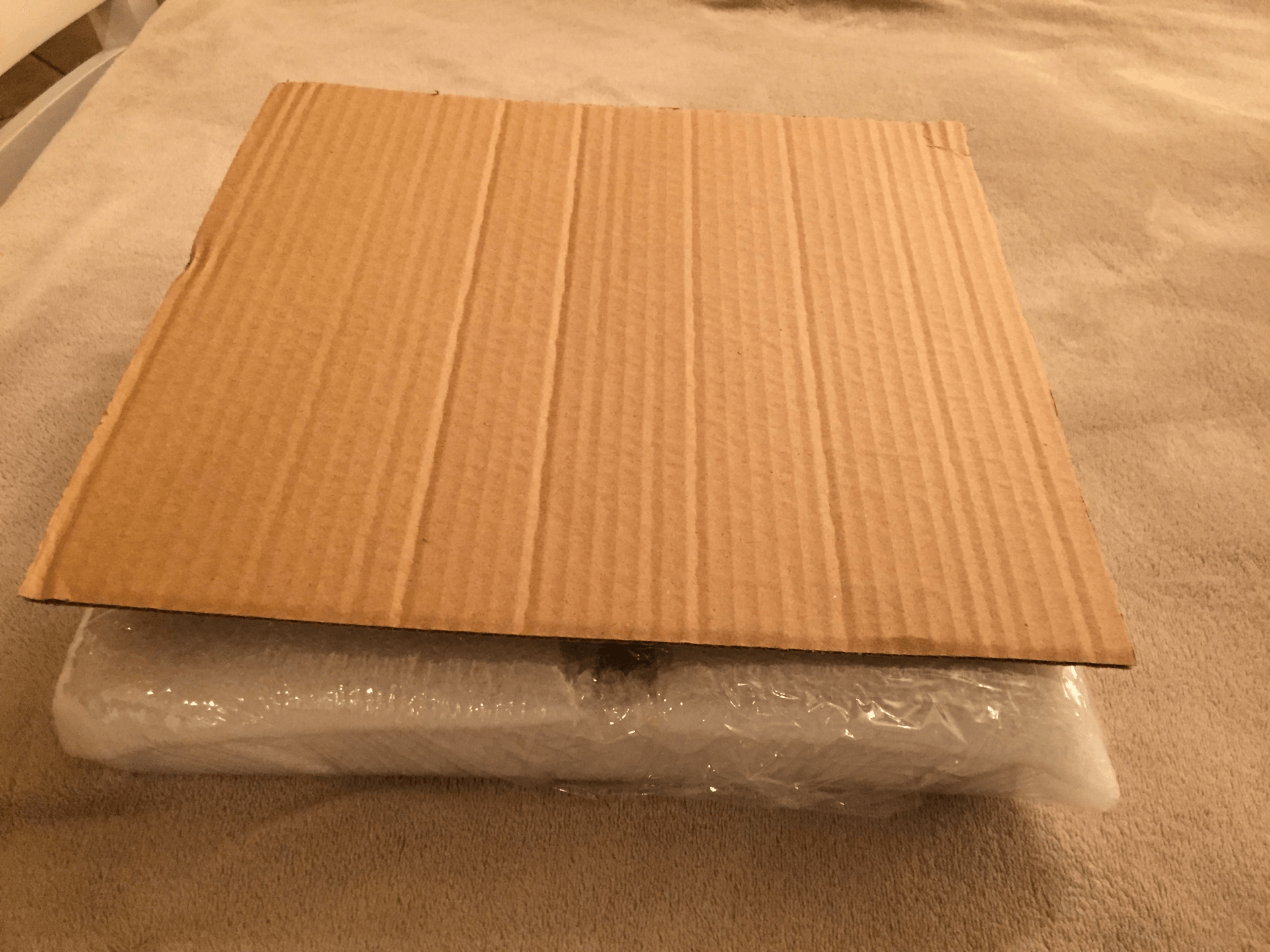package  wrapped in foam wrap and plastic wrap with cardboard box