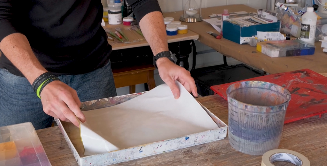 man putting sta-wet palette acrylic paper in the lid