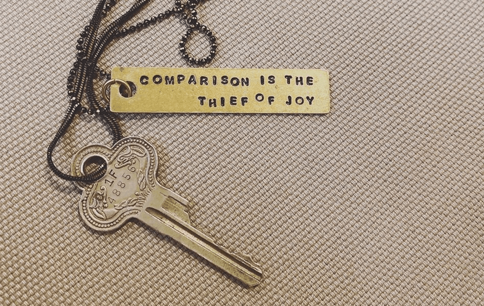 key with engraved numbers and a keychain with engraved quote comparison is the thief of joy