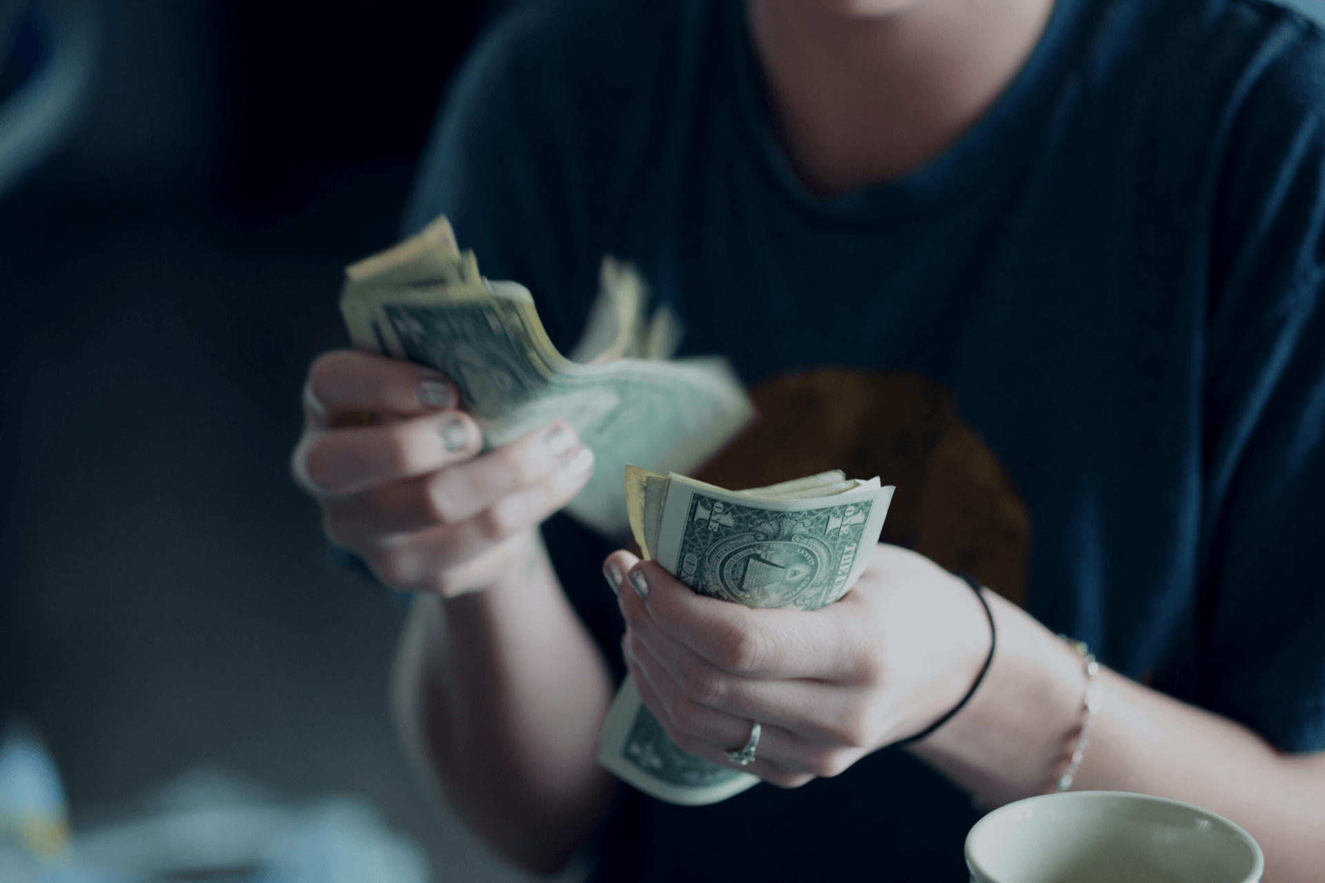 woman counting dollars in her hands